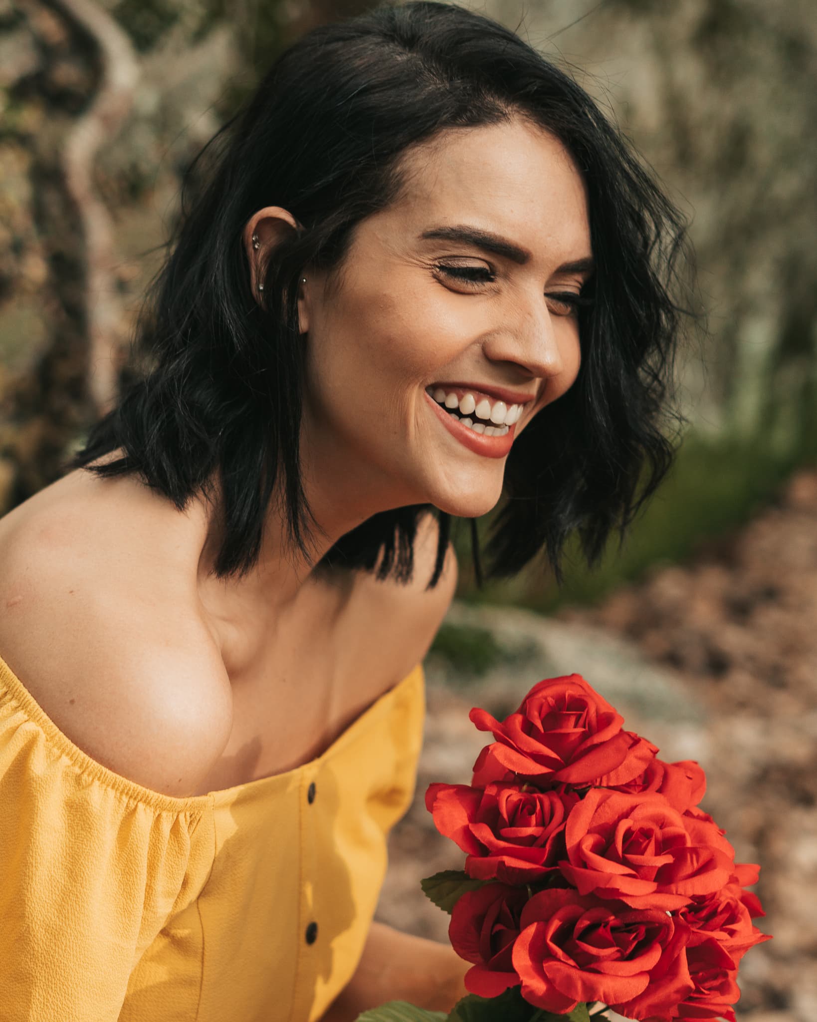 Woman laughing with red roses